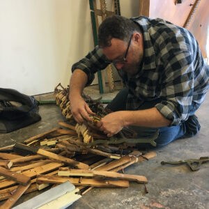 Wilson artist Jeff Bell dismantles a piano